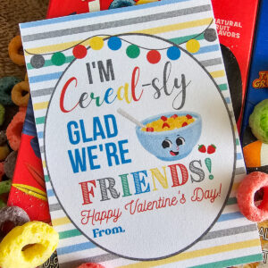 Valentine card with a colorful striped background, cute cereal bowl graphic, and colorful text that reads, "I'm cereal-sly glad we're friends! Happy Valentines Day! From, "